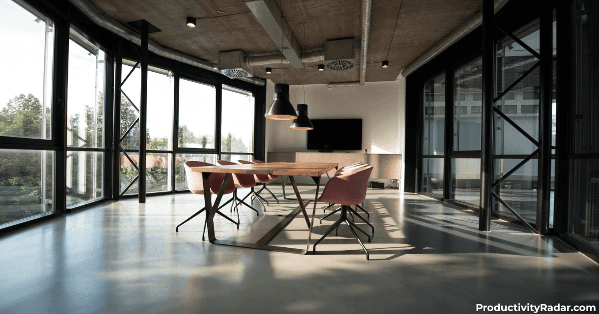Sunlit conference room with concrete ceiling and floor-to-ceiling windows - ChatGPT prompts for setting employee goals