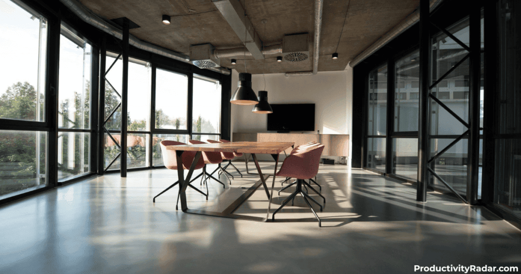 Sunlit conference room with wooden table and modern chairs - ChatGPT vs Claude for managers comparison