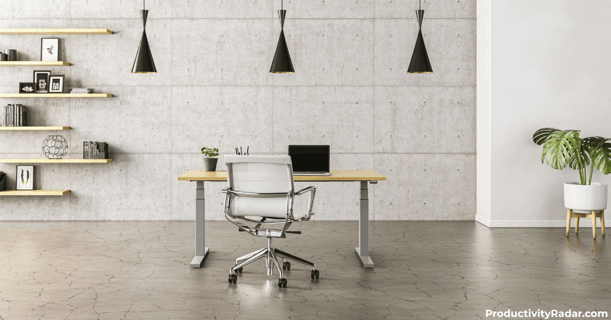 Minimalist office desk with laptop and modern chair against concrete wall - ChatGPT prompts for difficult employee conversations