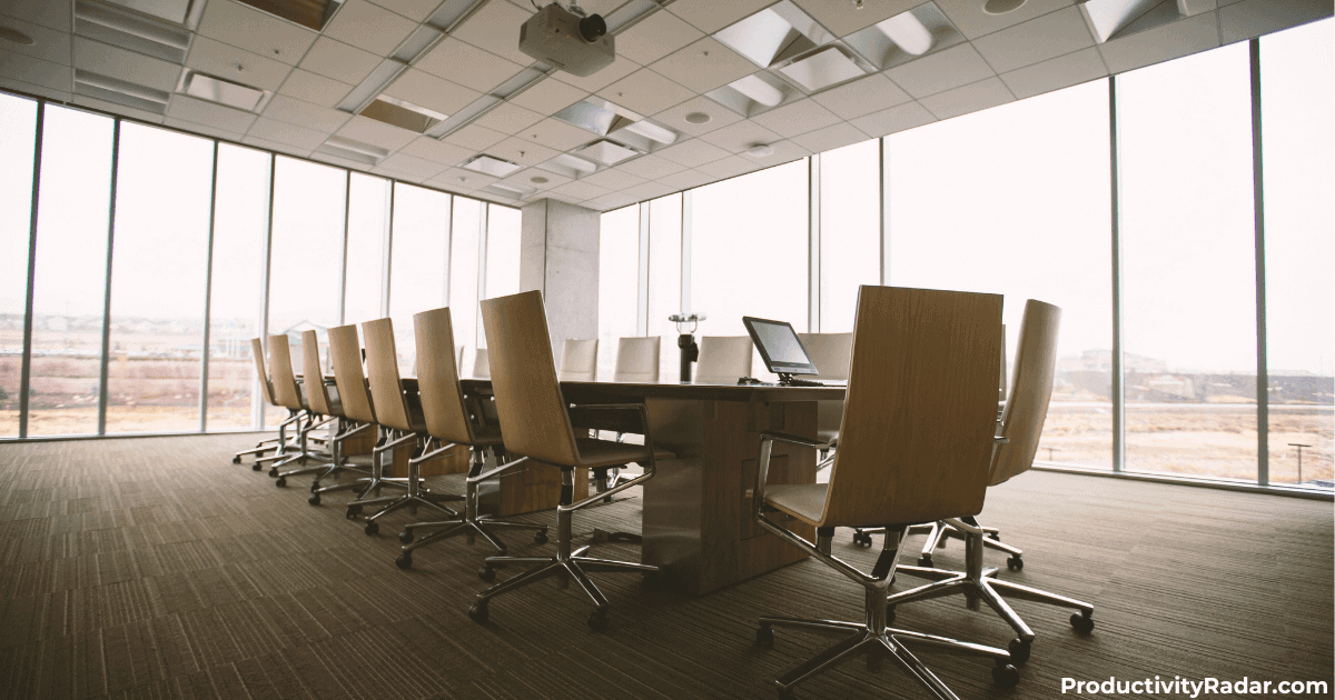 Executive boardroom with floor-to-ceiling windows and conference table - AI for weekly team updates