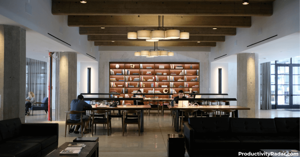 Open office lounge with exposed beam ceiling and built-in bookshelves - ChatGPT prompts for writing PIPs