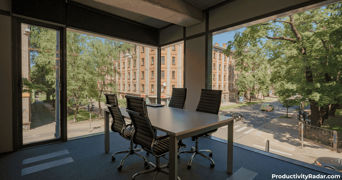 Small meeting room with panoramic windows and tree views - AI shortcuts for email