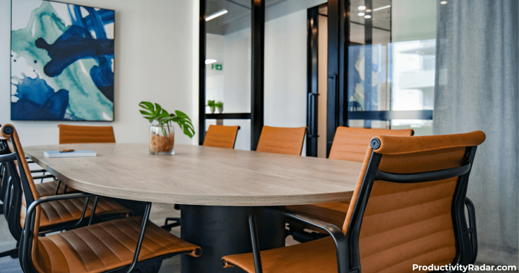 Conference room with leather chairs and abstract wall art - Claude prompts for performance reviews