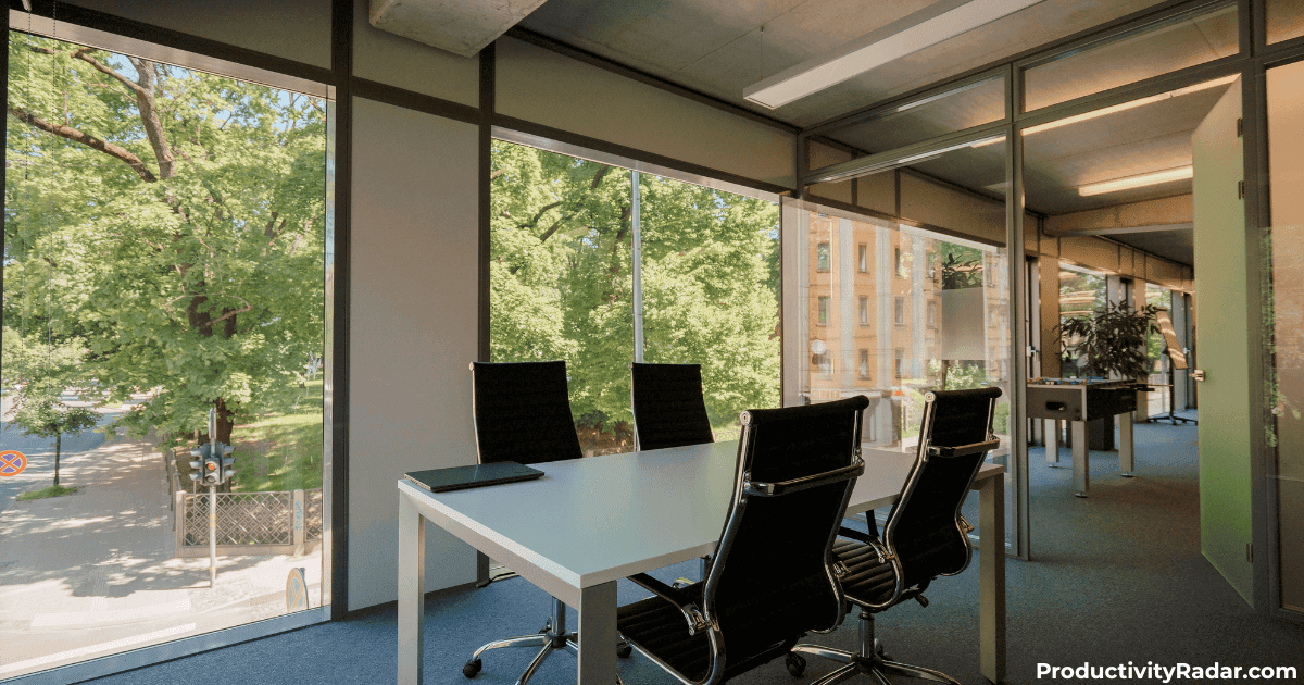 Modern office meeting room with laptop on table where managers might use Otter.ai for managers to transcribe conversations