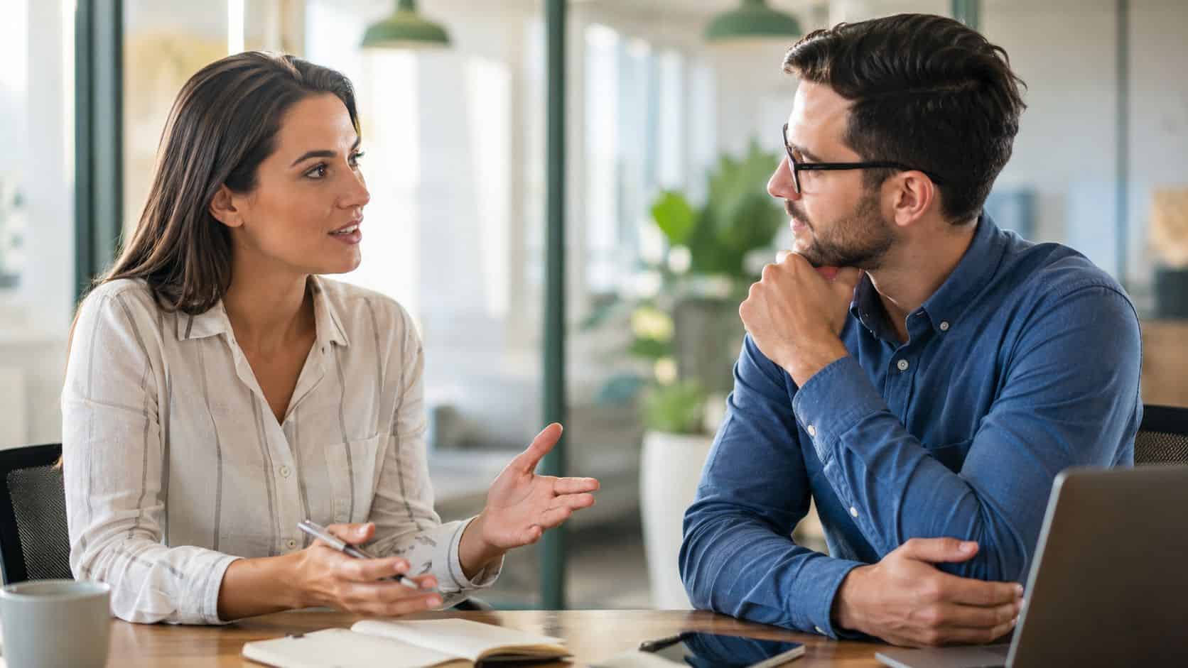 Manager coaching an employee one-on-one, showing how to be a good manager who builds the team's capability over time